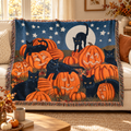 Moonlit Pumpkin Throw Blanket with black cats and jack-o’-lanterns styled on a cream sofa